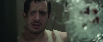 Movie still from “Maniac” (2012), directed by Franck Khalfoun – A person in a tank top; Close Up shot, Over the shoulder angle