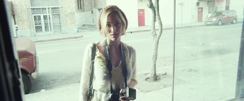 Movie still from “Maniac” (2012), directed by Franck Khalfoun – A beautiful blond haired woman holding a camera; Close Up shot, Low angle