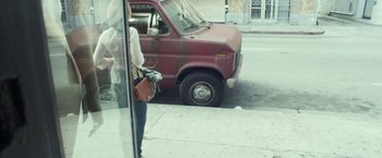 Movie still from “Maniac” (2012), directed by Franck Khalfoun – A woman standing in front of a parked red truck; Wide shot, High angle