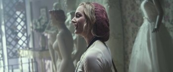Movie still from “Maniac” (2012), directed by Franck Khalfoun – A young woman wearing a pink hat is smiling for the camera; Close Up shot, Over the shoulder angle