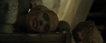 Movie still from “Maniac” (2012), directed by Franck Khalfoun – A woman laying on top of a wooden box; Extreme Close Up shot, Overhead angle