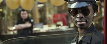 Movie still from “Maniac” (2012), directed by Franck Khalfoun – A person wearing a hat and sunglasses; Close Up shot, Over the shoulder angle