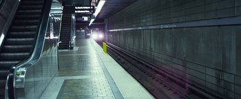 Movie still from “Maniac” (2012), directed by Franck Khalfoun – A train station with a train on the tracks; Extreme Wide shot, High angle