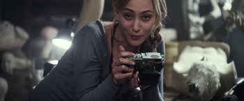 Movie still from “Maniac” (2012), directed by Franck Khalfoun – A woman is holding a camera in her hands; Close Up shot, Over the shoulder angle