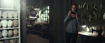 Movie still from “Maniac” (2012), directed by Franck Khalfoun – A woman taking a picture of a kitchen with a cell phone; Medium shot, Over the shoulder angle