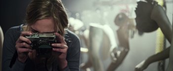 Movie still from “Maniac” (2012), directed by Franck Khalfoun – A woman taking a picture with a camera; Close Up shot, Low angle