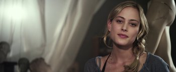 Movie still from “Maniac” (2012), directed by Franck Khalfoun – A beautiful young lady wearing a necklace and posing for a picture; Close Up shot, Over the shoulder angle