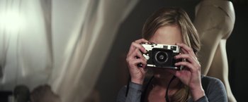 Movie still from “Maniac” (2012), directed by Franck Khalfoun – A woman taking a picture of herself with a camera; Close Up shot, Low angle