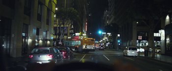 Movie still from “Maniac” (2012), directed by Franck Khalfoun – A city street at night with cars and a bus; Extreme Wide shot, High angle