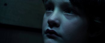 Movie still from “Maniac” (2012), directed by Franck Khalfoun – A child's face in the dark; Extreme Close Up shot, High angle