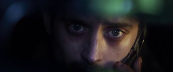 Movie still from “Maniac” (2012), directed by Franck Khalfoun – A man's eyes with a green light in the background; Extreme Close Up shot, Low angle