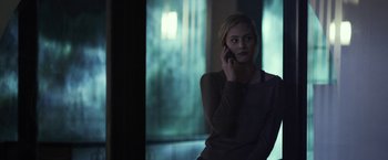 Movie still from “Maniac” (2012), directed by Franck Khalfoun – A woman is talking on a cell phone; Medium shot, Low angle