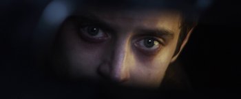 Movie still from “Maniac” (2012), directed by Franck Khalfoun – A person's eyes in the dark; Extreme Close Up shot, Low angle