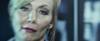 Movie still from “Maniac” (2012), directed by Franck Khalfoun – A woman's face with gold eye shadow; Extreme Close Up shot, Low angle