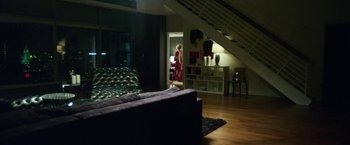 Movie still from “Maniac” (2012), directed by Franck Khalfoun – A woman standing in a living room next to a couch; Wide shot, Low angle