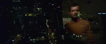 Movie still from “Maniac” (2012), directed by Franck Khalfoun – A man standing in front of a window at night; Medium shot, High angle