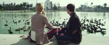 Movie still from “Maniac” (2012), directed by Franck Khalfoun – A man and a woman sitting next to a body of water; Wide shot, Over the shoulder angle