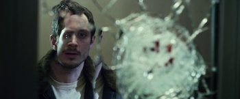 Movie still from “Maniac” (2012), directed by Franck Khalfoun – A man is looking at a shattered glass window; Close Up shot, Low angle
