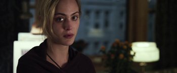 Movie still from “Maniac” (2012), directed by Franck Khalfoun – A beautiful young lady with blonde hair wearing a maroon shirt; Close Up shot, Over the shoulder angle