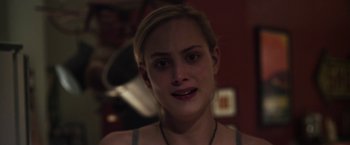 Movie still from “Maniac” (2012), directed by Franck Khalfoun – A woman's face in a dark room; Close Up shot, Over the shoulder angle