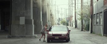 Movie still from “Maniac” (2012), directed by Franck Khalfoun – A woman pushing a car on the sidewalk; Wide shot, High angle
