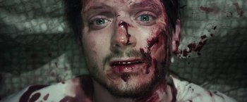 Movie still from “Maniac” (2012), directed by Franck Khalfoun – A person's face covered in blood; Close Up shot, Overhead angle