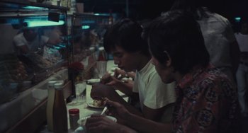 A group of people sitting at a table eating food