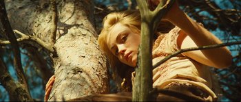 Movie still from “Manon of the Spring” (1986), directed by Claude Berri – A young woman leaning up against a tree; Close Up shot, Low angle