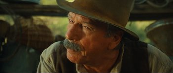 Movie still from “Manon of the Spring” (1986), directed by Claude Berri – An older man with a mustache and a cowboy hat; Close Up shot, Over the shoulder angle