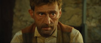 Movie still from “Manon of the Spring” (1986), directed by Claude Berri – A person with a beard and a mustache; Close Up shot, Low angle