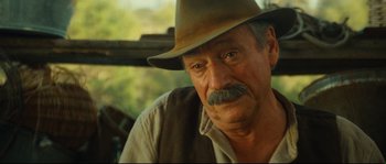 Movie still from “Manon of the Spring” (1986), directed by Claude Berri – An older man with a mustache and a hat; Close Up shot, Over the shoulder angle