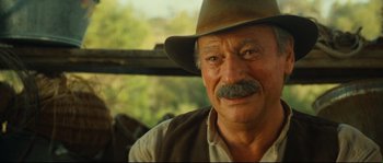 Movie still from “Manon of the Spring” (1986), directed by Claude Berri – An older man with a mustache and a hat; Close Up shot, Over the shoulder angle