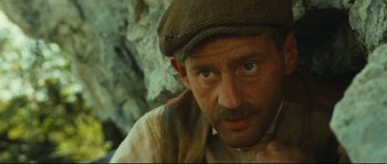 Movie still from “Manon of the Spring” (1986), directed by Claude Berri – A person wearing a hat; Close Up shot, Low angle