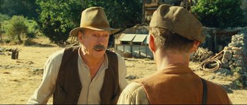 Movie still from “Manon of the Spring” (1986), directed by Claude Berri – A man in a hat talking to another man in a hat; Close Up shot, Over the shoulder angle