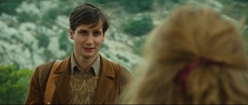 Movie still from “Manon of the Spring” (1986), directed by Claude Berri – A young man in a brown jacket is looking at a woman; Close Up shot, Over the shoulder angle