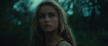 Movie still from “Manon of the Spring” (1986), directed by Claude Berri – A beautiful young woman with long blonde hair and blue eyes; Close Up shot, Over the shoulder angle