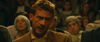 Movie still from “Manon of the Spring” (1986), directed by Claude Berri – A person wearing a suit and tie; Close Up shot, Over the shoulder angle