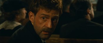 Movie still from “Manon of the Spring” (1986), directed by Claude Berri – A person wearing a suit and tie; Close Up shot, Over the shoulder angle