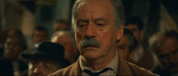 Movie still from “Manon of the Spring” (1986), directed by Claude Berri – An old man with a mustache and a beard; Close Up shot, Over the shoulder angle