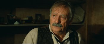 Movie still from “Manon of the Spring” (1986), directed by Claude Berri – An older man with a mustache and a mustache comb; Close Up shot, High angle