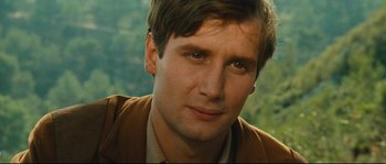 Movie still from “Manon of the Spring” (1986), directed by Claude Berri – A man's face with trees in the background; Close Up shot, High angle