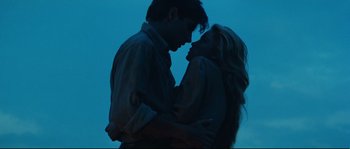 Movie still from “Manon of the Spring” (1986), directed by Claude Berri – A man and a woman embracing in the dark at night; Medium shot, Low angle