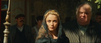 Movie still from “Manon of the Spring” (1986), directed by Claude Berri – A woman in a black dress with a black veil; Close Up shot, Over the shoulder angle