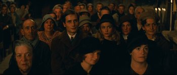 Movie still from “Manon of the Spring” (1986), directed by Claude Berri – A group of people sitting in front of each other; Medium shot, Over the shoulder angle