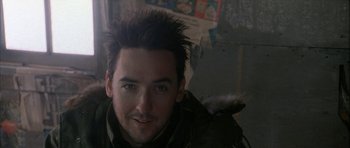 Movie still from “Map of the Human Heart” (1992), directed by Vincent Ward – A person wearing a jacket; Close Up shot, Over the shoulder angle