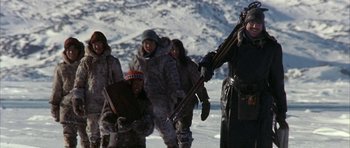Movie still from “Map of the Human Heart” (1992), directed by Vincent Ward – A group of people standing on top of a snow covered slope; Wide shot, Low angle