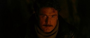 Movie still from “Map of the Human Heart” (1992), directed by Vincent Ward – A person with a mustache; Close Up shot, Low angle