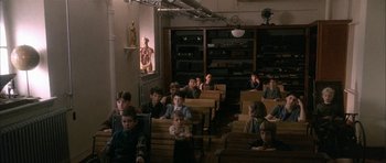 Movie still from “Map of the Human Heart” (1992), directed by Vincent Ward – A group of children sitting in a classroom; Wide shot, High angle
