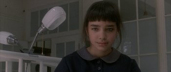 Movie still from “Map of the Human Heart” (1992), directed by Vincent Ward – A young girl with bangs is looking at the camera; Close Up shot, High angle