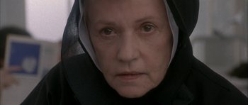 Movie still from “Map of the Human Heart” (1992), directed by Vincent Ward – An older woman wearing a nun's habit looking at the camera; Close Up shot, Low angle